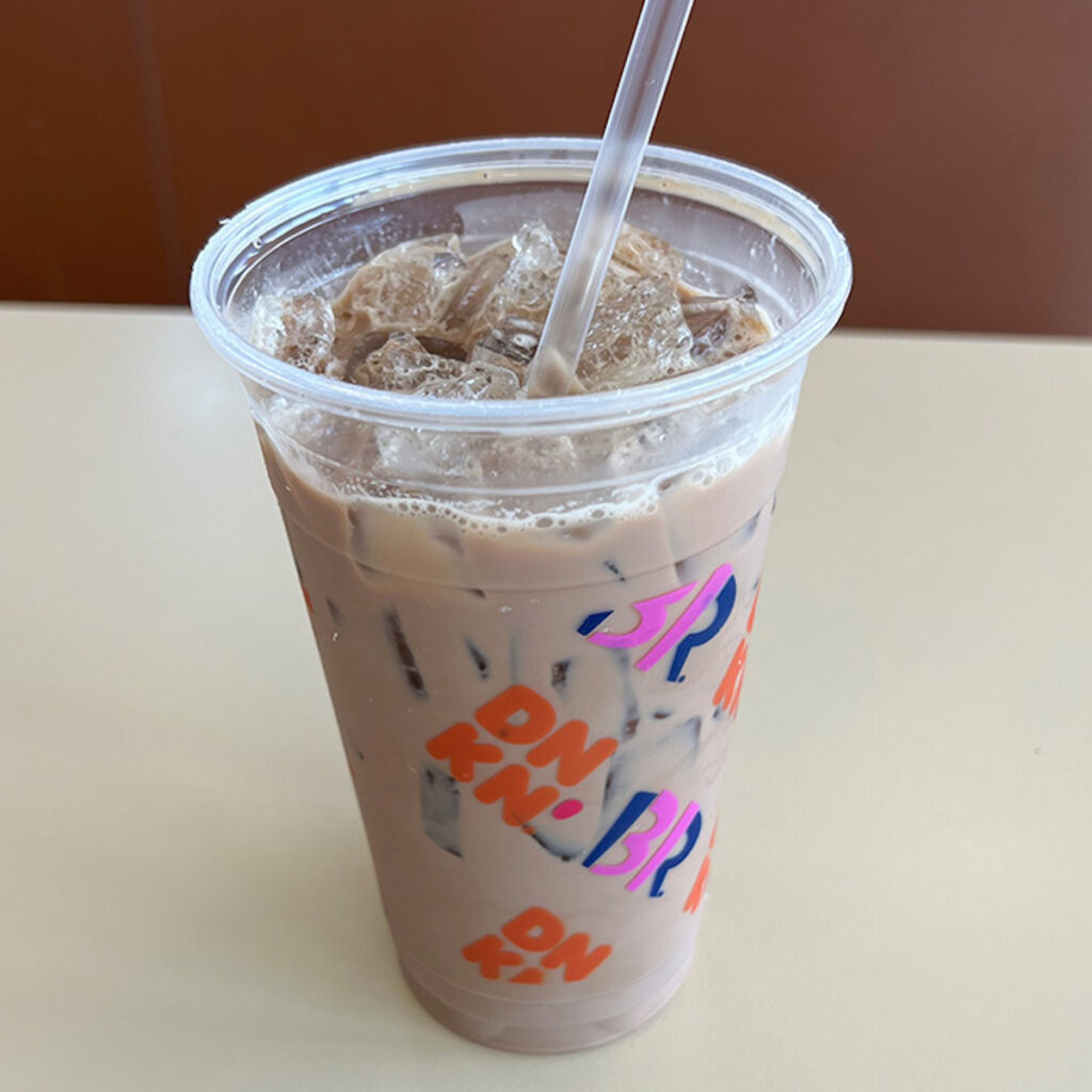 cup of dunkin donuts iced coffee with a straw