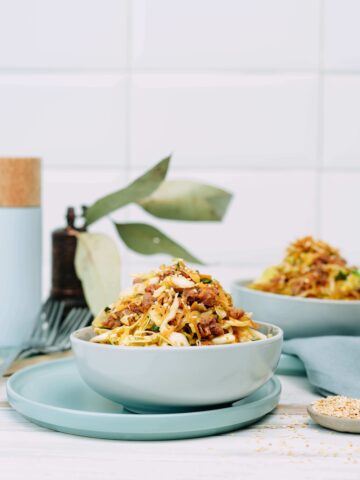 Table top set with light blue dishware holding bowls of egg roll in a bowl on keto