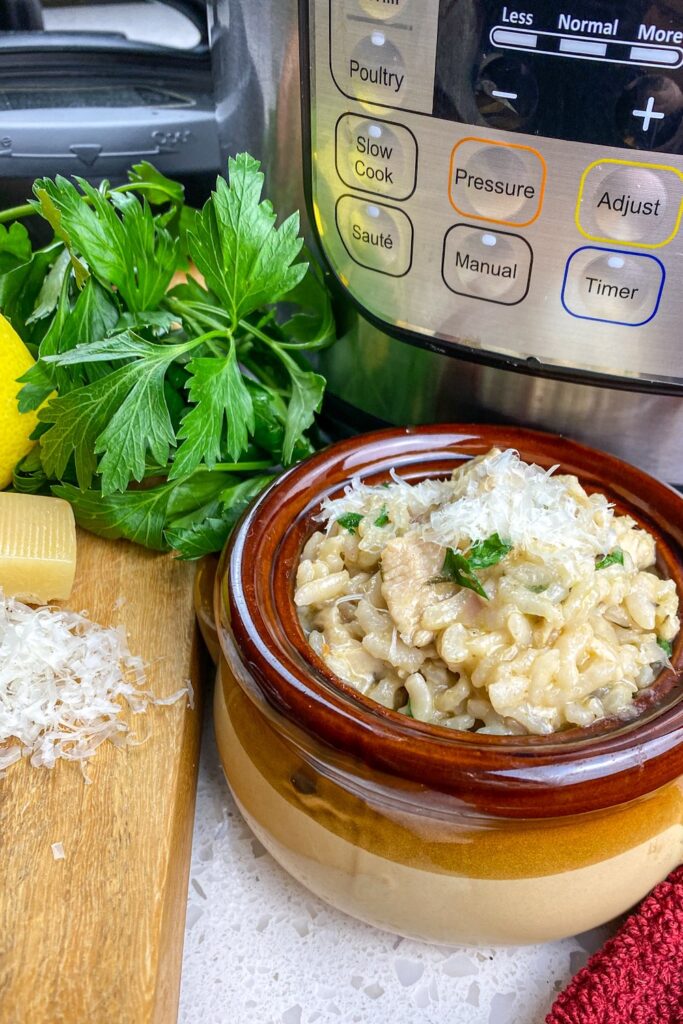 instant pot, bowl of lemon parsley chicken risotto and fresh parsley