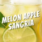 glass of melon apple sangria with a slice of lime