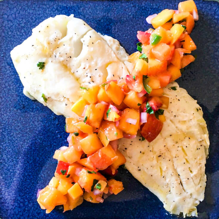 spicy peach salsa on a cooked fillet of fish