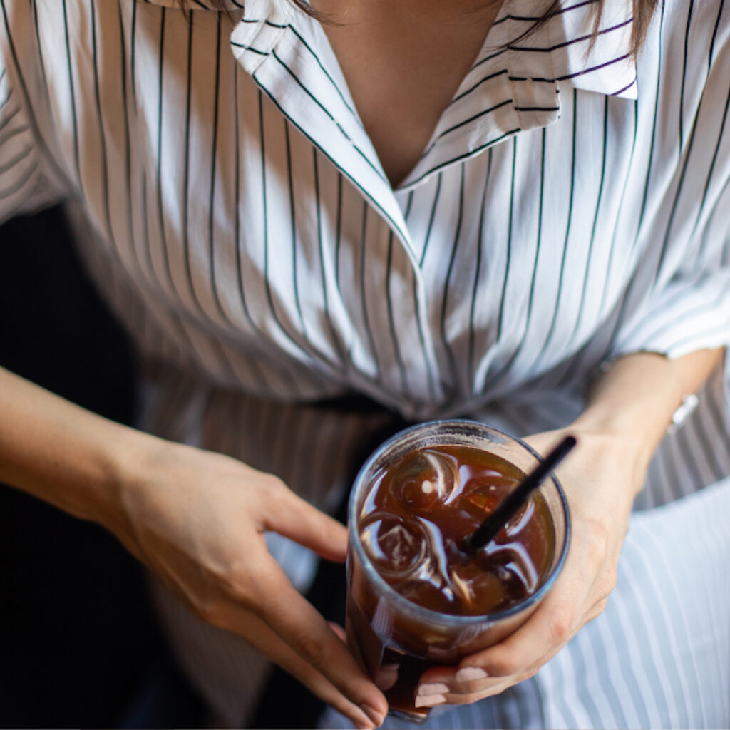 woman holding a cup of iced coffee made from cold brew