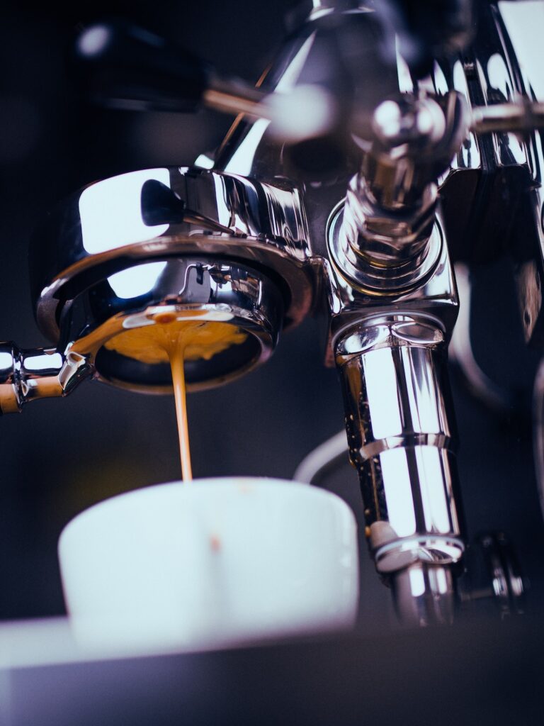 espresso pouring into cup from espresso machine