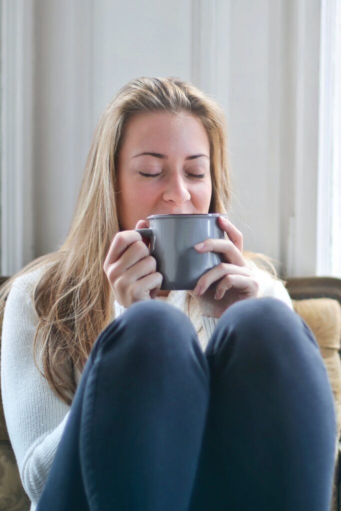 woman enjoying a cozy mug of coffee