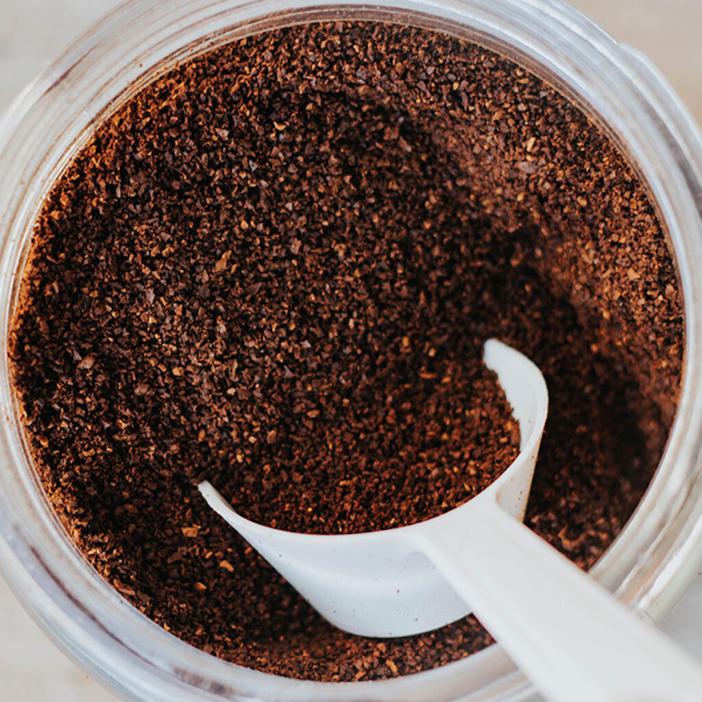 white scoop of coffee grounds