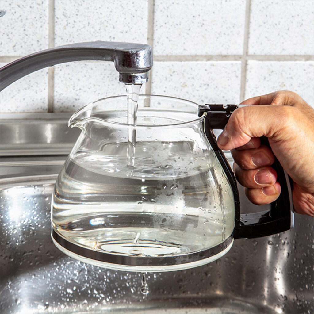 glass coffee pot filling with water