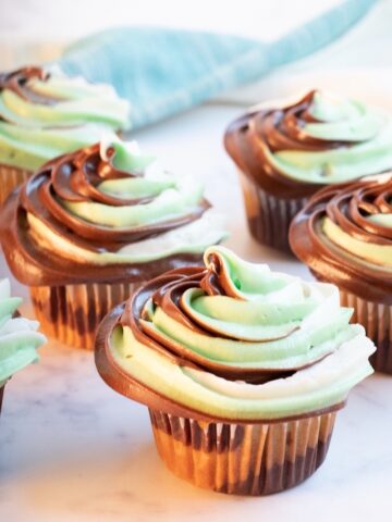 camouflage cupcakes with white green and brown swirled frosting