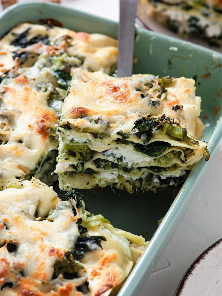 spicnach broccoli lasagna being scooped from the pan