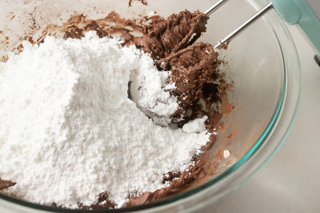 Mixing in powdered sugar in large bowl