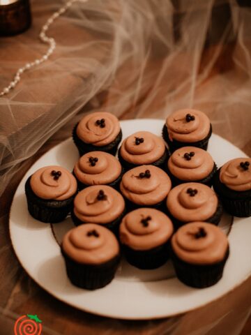 plate of mini chocolate cupcakes with chocolate frosting