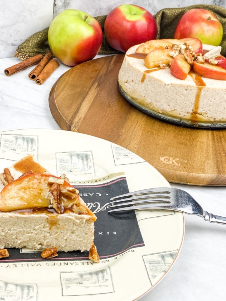 slice of apple cinnamon cheesecake on a plate with a fork