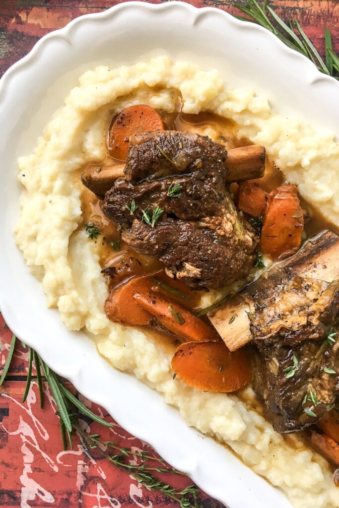 Instant Pot beef short ribs from Flavor Portal recipe on a bed of mashed potatoes