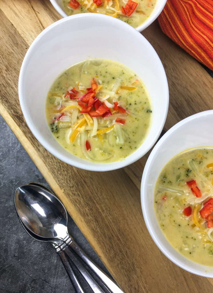 Instant Pot broccoli cheese soup from Flavor Portal recipe in two white bowls with two spoons