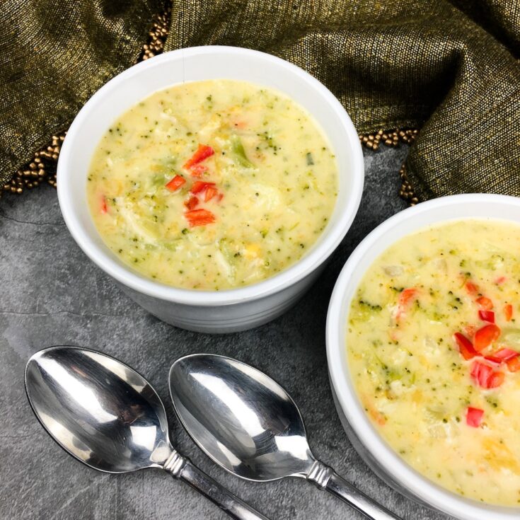 Instant Pot broccoli cheese soup from Flavor Portal recipe in two white bowls with two spoons