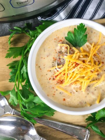 top view Instant Pot Cheeseburger Soup from Flavor Portal recipe in white bowl in front of Instant Pot