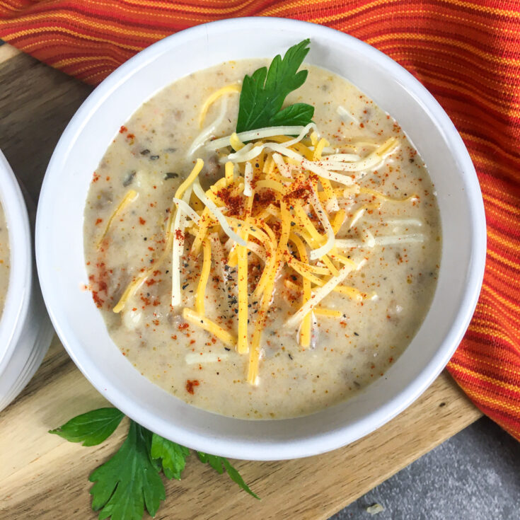 top view Instant Pot Cheeseburger Soup from Flavor Portal recipe in white bowl in front of Instant Pot