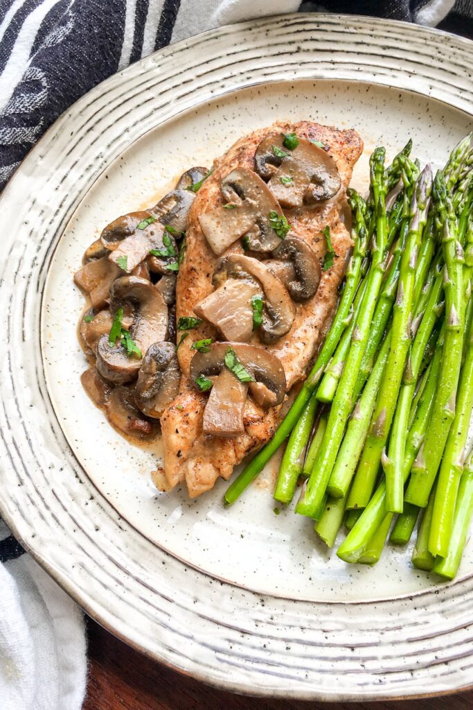 Instant Pot Chicken Lanzone from Flavor Portal recipe on vintage plate with asparagus spears