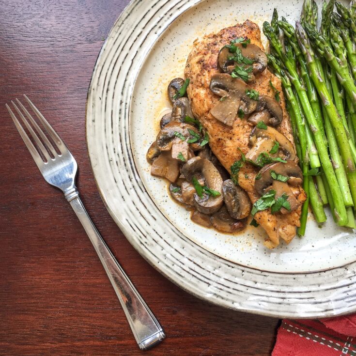 Instant Pot Chicken Lanzone from Flavor Portal recipe on vintage plate with asparagus spears