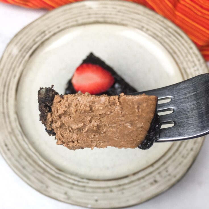 closeup of fork with bite of Instant Pot Chocolate Cheesecake from Flavor Portal recipe