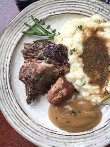 Instant Pot cocoa spiced pork roast from Flavor Portal recipe on a plate with mashed potatoes and gravy