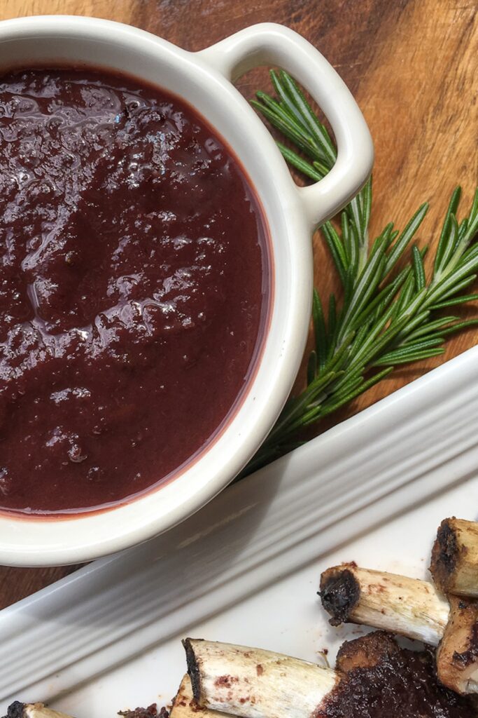 Instant Pot dark cherry bbq sauce in white container for flavor portal