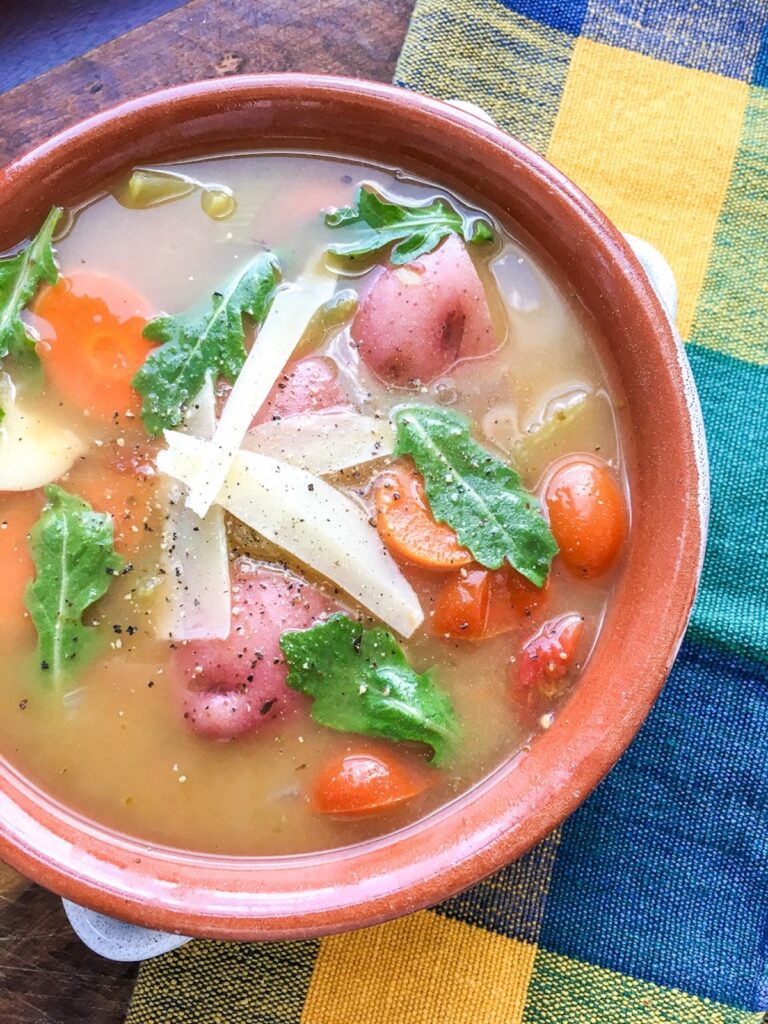 garden vegetable soup on yellow and blue tablecloth background