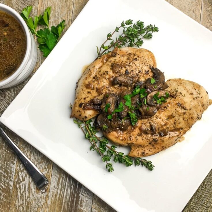 instant pot Italian chicken breasts from Flavor Portal recipe on a square white plate garnished with parsley and thyme.