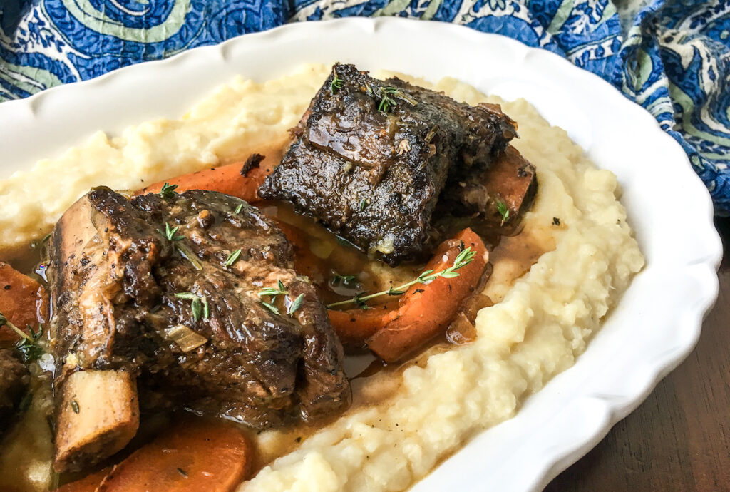 closeup Instant Pot beef short ribs from Flavor Portal recipe on a bed of mashed potatoes