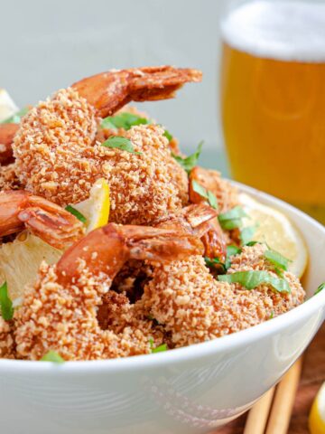lemon panko fried shrimp from Flavor Portal recipe in a white bowl beside a glass of beer