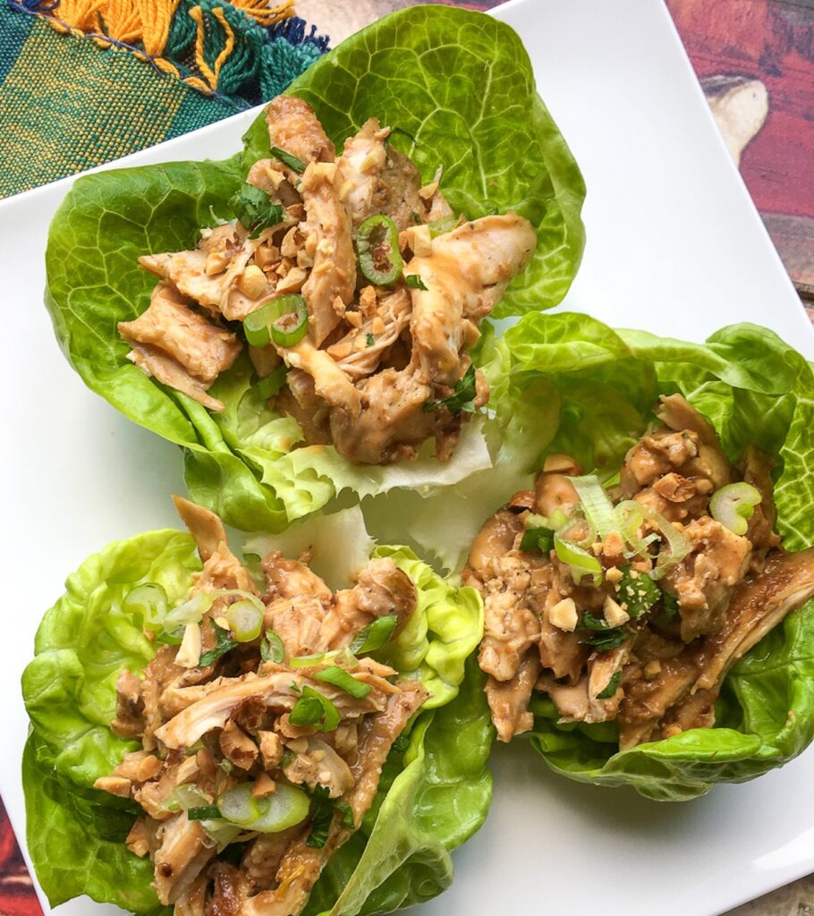 Instant pot Thai chicken wraps on a white plate for Flavor Portal