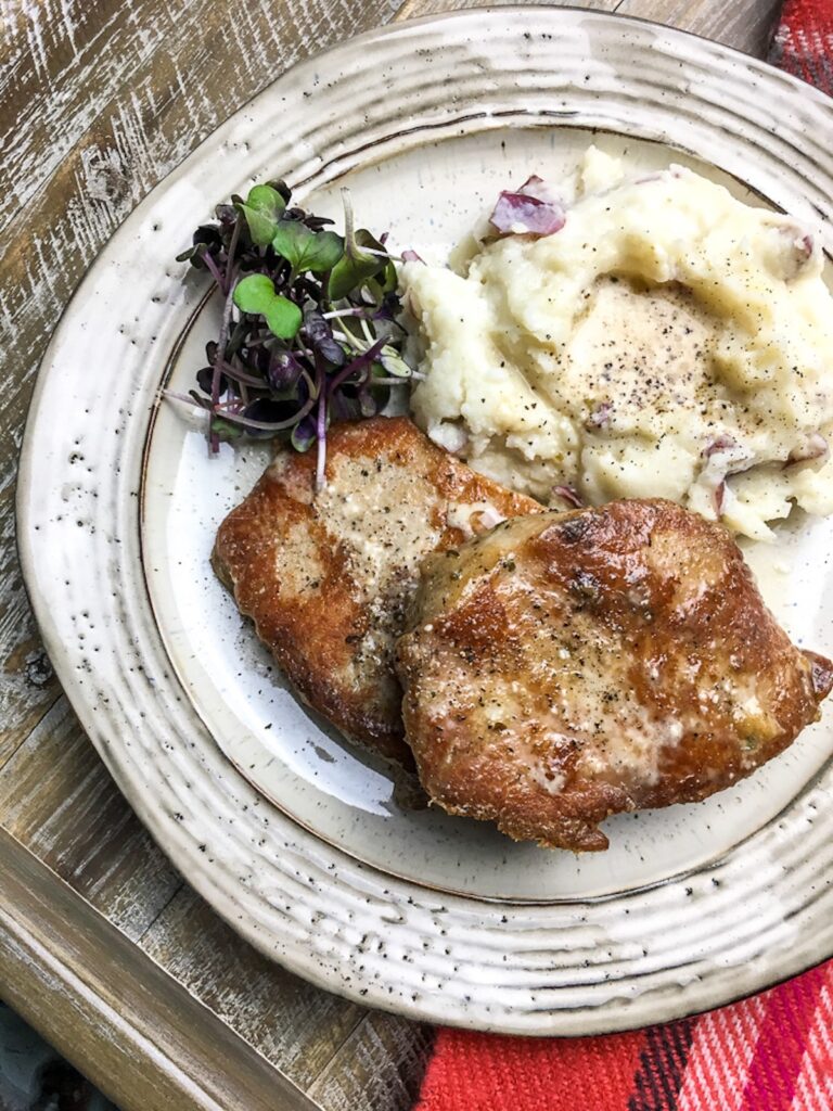 Instant Pot boneless pork chops from Flavor Portal recipe with creamy mashed potatoes and microgreens
