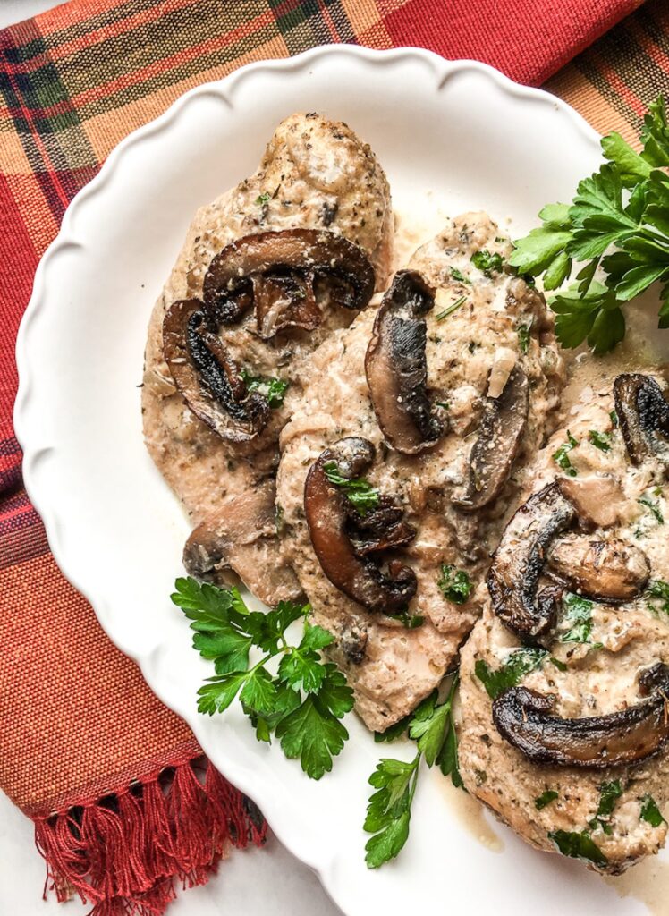 chicken marsala on a white platter with Portobello mushrooms for flavor portal