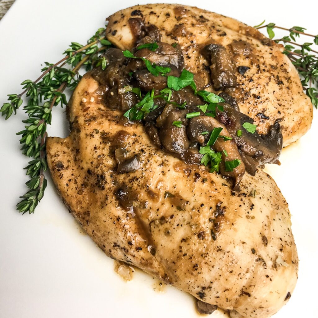 Instant Pot Italian Chicken Breasts from Flavor Portal recipe topped with mushrooms with thyme twigs