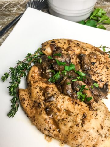 Instant Pot Italian Chicken Breasts from Flavor Portal recipe topped with mushrooms with thyme twigs