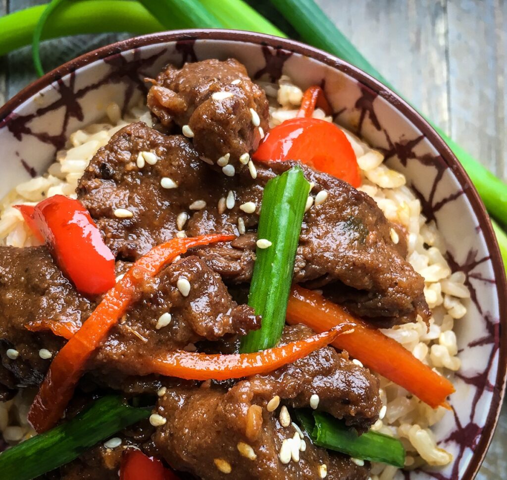 Instant Pot mongolian beef from Flavor Portal recipe on rice in a bowl