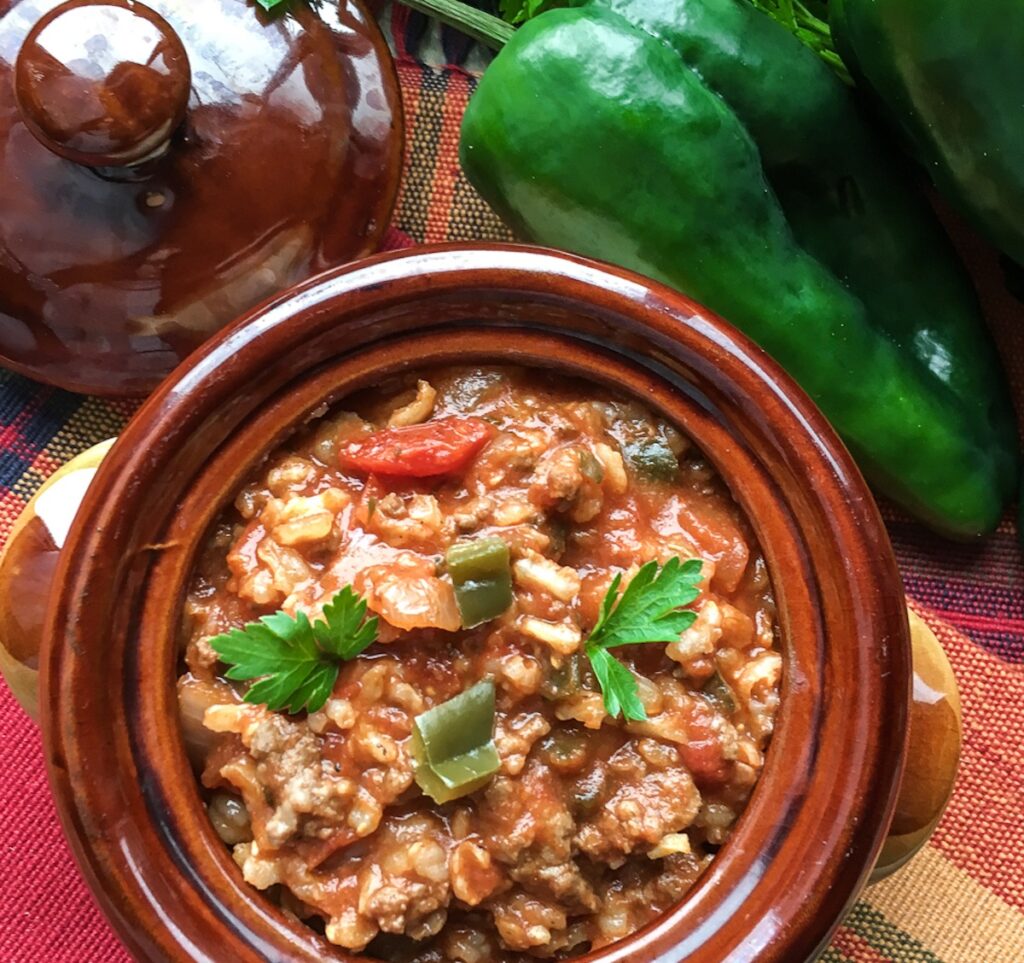 Instant Pot Stuffed Poblano Pepper Soup from Flavor Portal recipe in a brown stoneware bowl next to fresh veggies