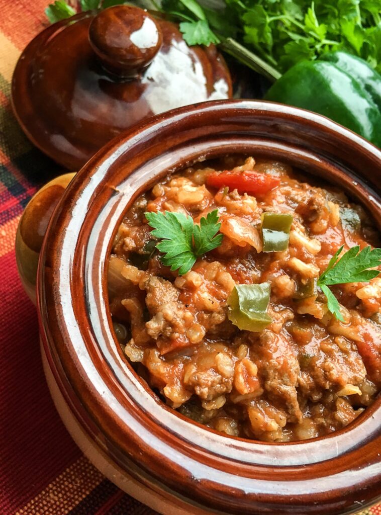 Instant Pot Stuffed Poblano Pepper Soup from Flavor Portal recipe in a brown stoneware bowl next to fresh veggies