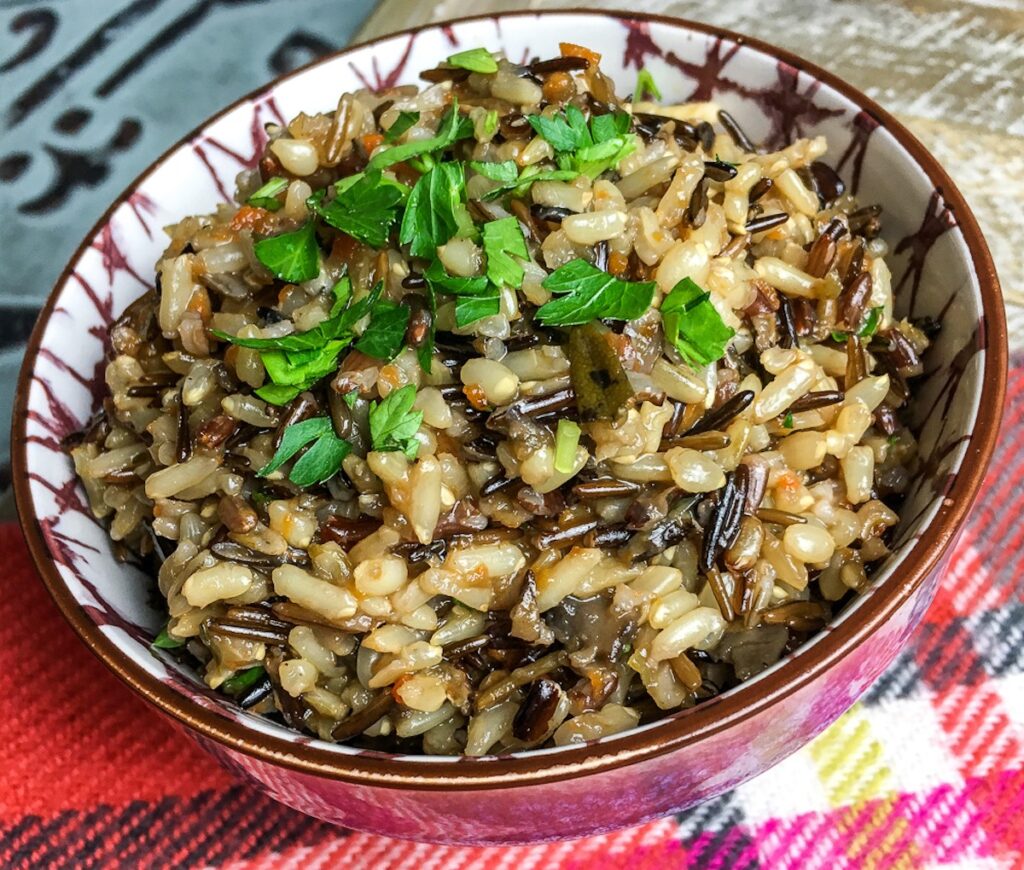Instant Pot Wild Rice Pilaf from Flavor Portal recipe in ceramic bowl and garnished with chopped parsley