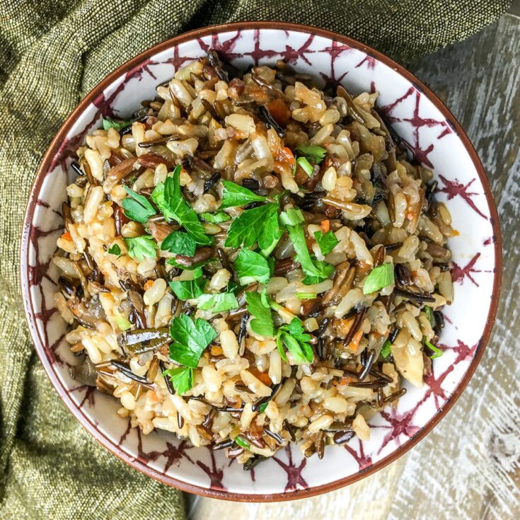 Instant Pot Wild Rice Pilaf from Flavor Portal recipe in ceramic bowl and garnished with chopped parsley