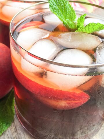 Instant Pot Ginger Peach Iced Tea from Flavor Portal recipe in a glass with a mint sprig