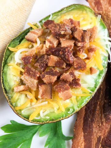 keto avocado baked eggs from Flavor Portal recipe with bits and strips of bacon