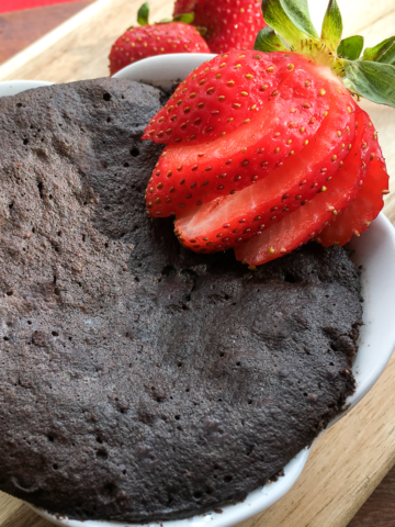 top view Keto Chocolate Mug Cake from Flavor Portal recipe garnished with sliced fresh strawberries