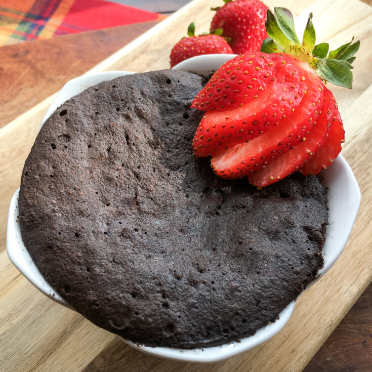 top view Keto Chocolate Mug Cake from Flavor Portal recipe garnished with sliced fresh strawberries