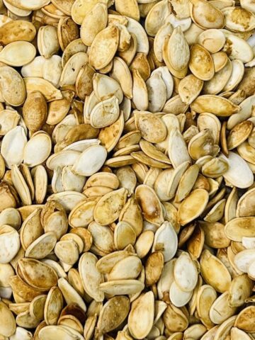 closeup of a big pile of pumpkin seeds for the guess how many in the mason jar game