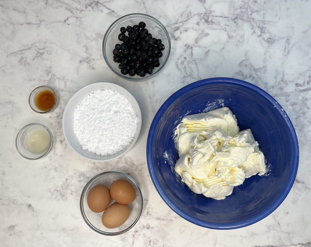keto blueberry jamboree cheesecake filling ingredients in separate bowls