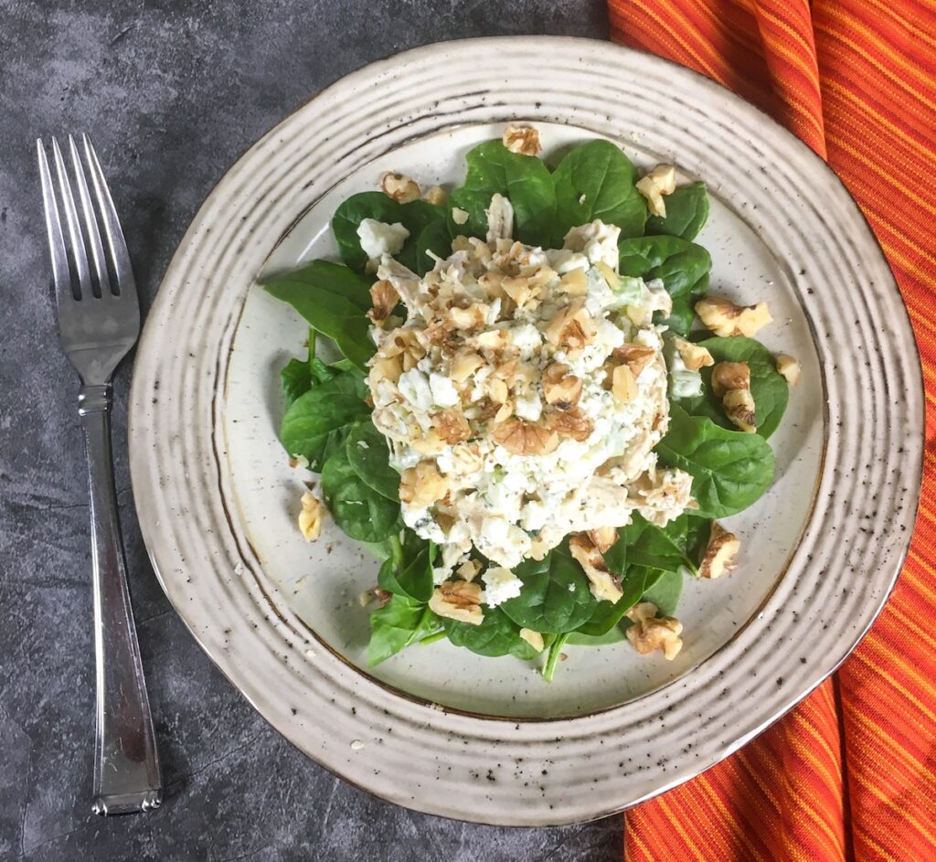 keto chicken salad from Flavor Portal recipe on a vintage ceramic plate with an orange striped napkin