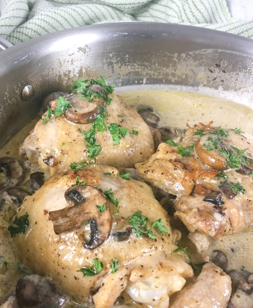 keto creamy chicken thighs from Flavor Portal recipe in stainless steel bowl