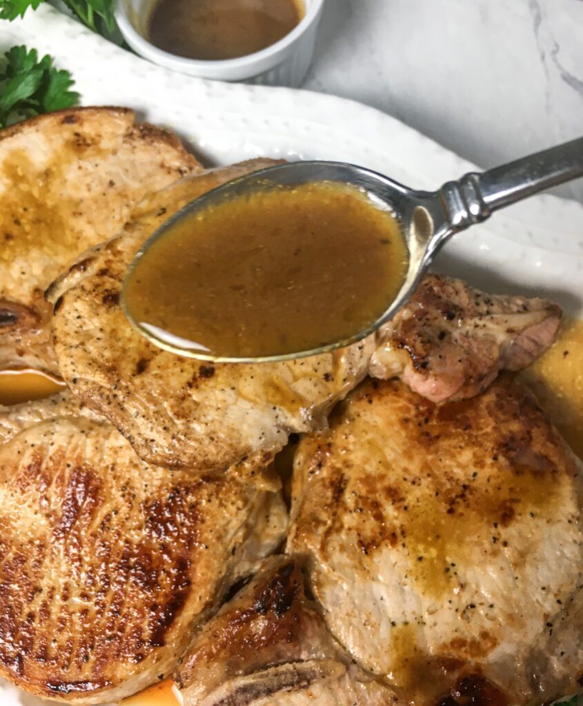 keto pork chops from Flavor Portal recipe on a white platter garnished with parsley