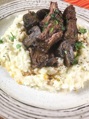 keto pot roast from Flavor Portal recipe on riced cauliflower and garnished with parsley