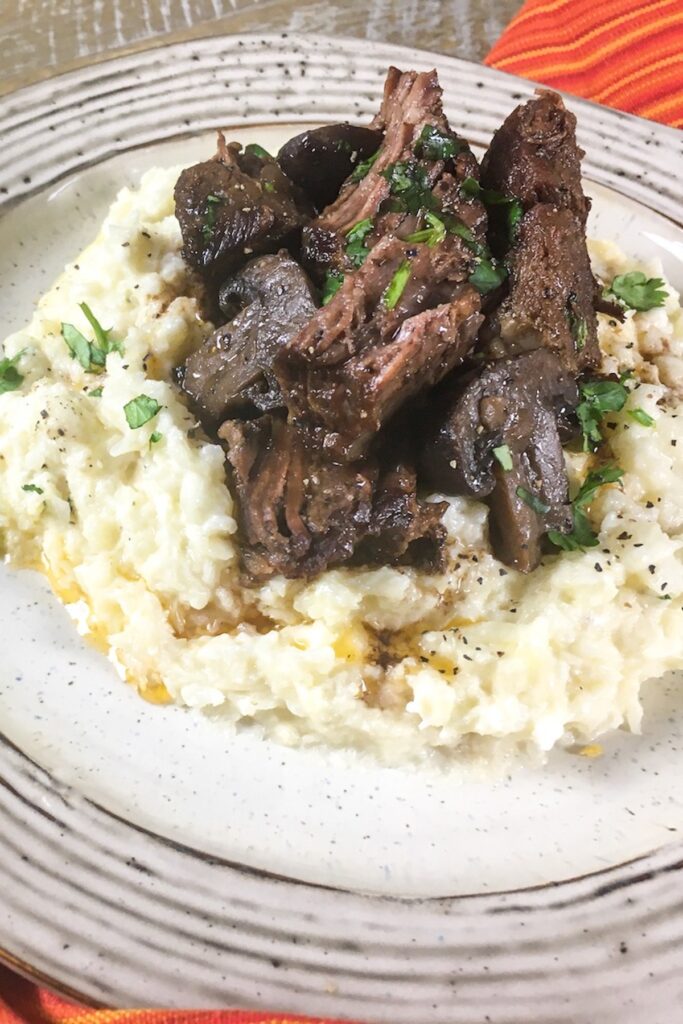 keto pot roast from Flavor Portal recipe on riced cauliflower and garnished with parsley